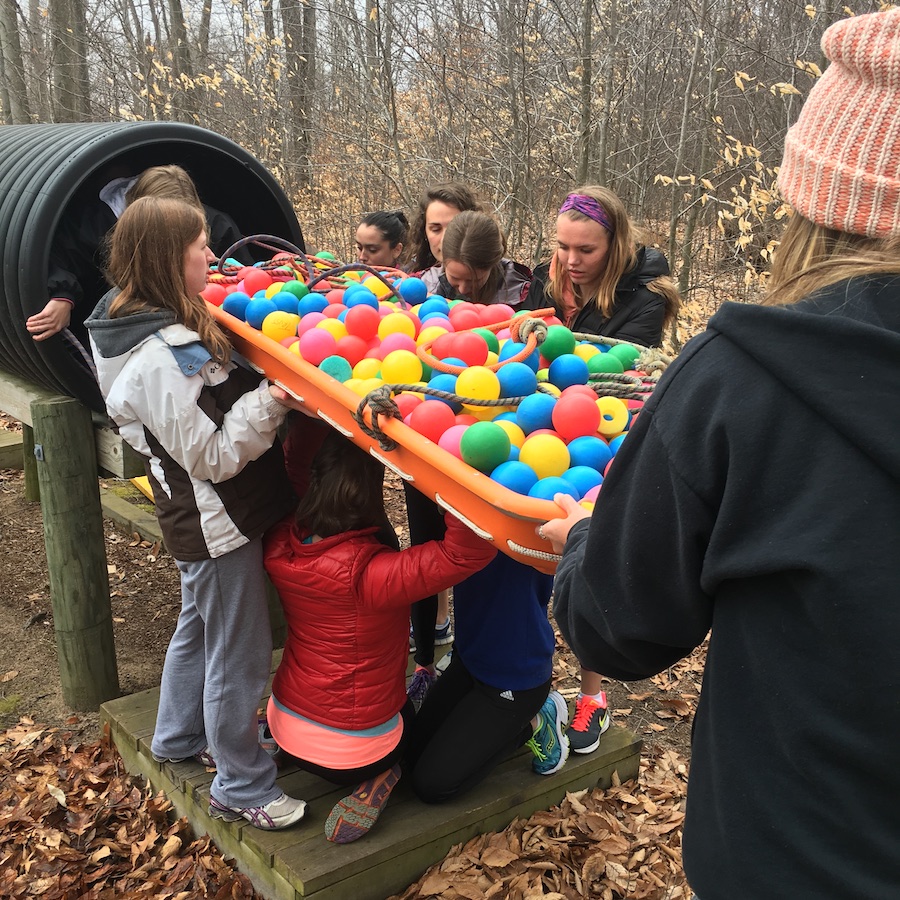 A retreat group works through a simulated mountain rescue challenge