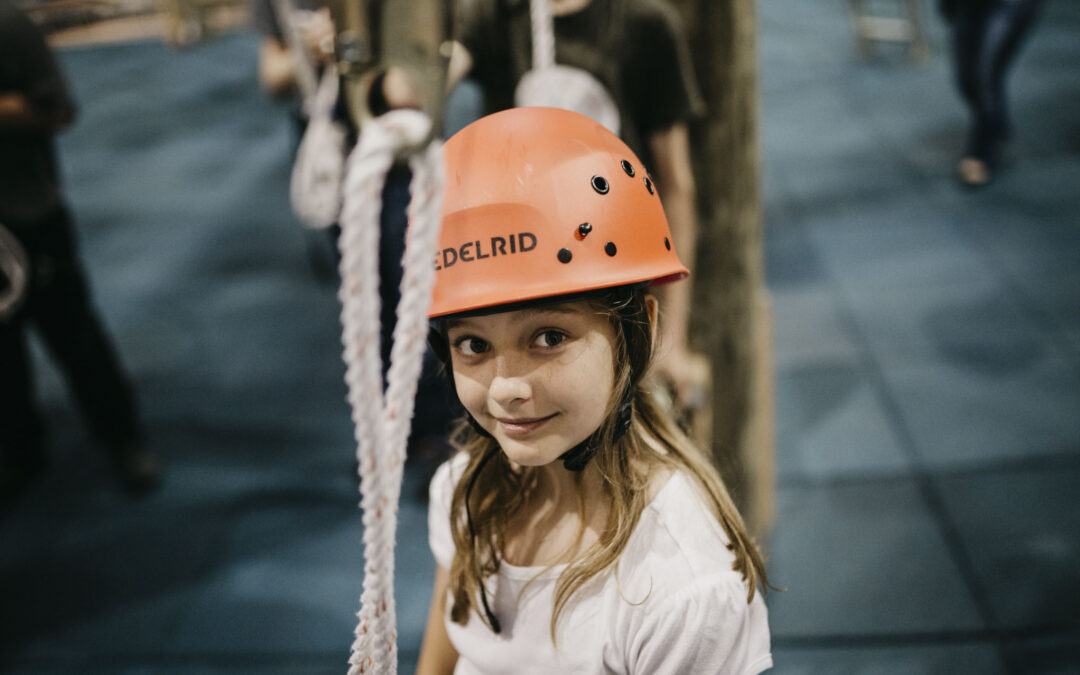 girl awaits her turn on the ropes course